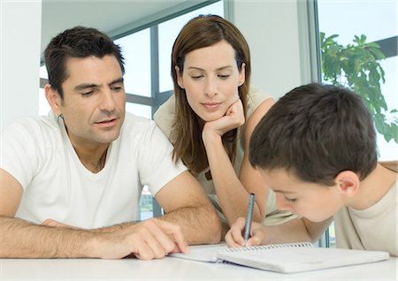 Parents helping son with homework Stock Photo - Premium Royalty-Free, Code: 695-05762472