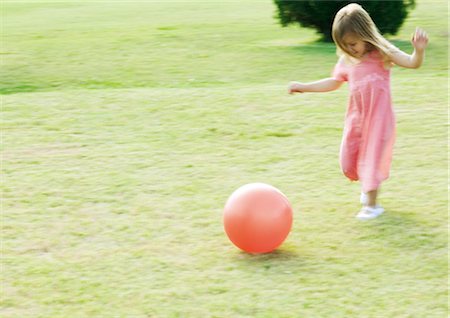 Girl running after ball, blurred motion Stock Photo - Premium Royalty-Free, Code: 695-05762493
