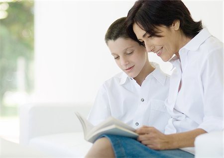 Boy reading book with mature woman Stock Photo - Premium Royalty-Free, Code: 695-05762504