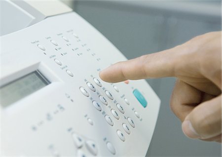 fax - Man's finger about to push button on fax machine Fotografie stock - Premium Royalty-Free, Codice: 695-05763130