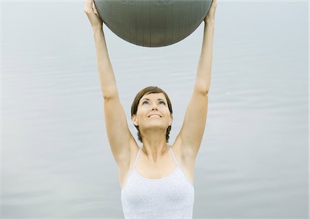 fitness   mature woman - Woman exercising with fitness ball, next to lake Stock Photo - Premium Royalty-Free, Code: 695-05763252