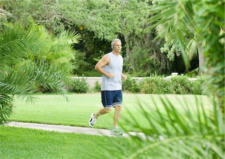 Man jogging in park Stock Photo - Premium Royalty-Free, Code: 695-05763289