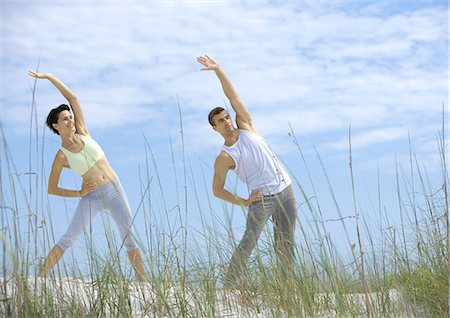 simsearch:695-03373919,k - Man and woman doing side stretches on beach Stock Photo - Premium Royalty-Free, Code: 695-05763453