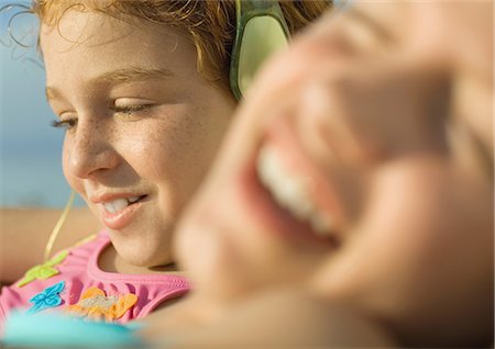 redhead girl swim suit - Girl in bathing suit listening to earphones Stock Photo - Premium Royalty-Free, Code: 695-05763589