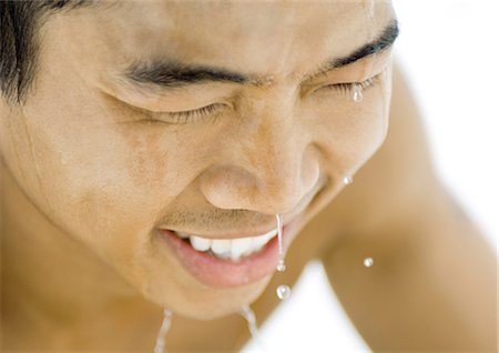 Young man with water dripping from face Stock Photo - Premium Royalty-Free, Code: 695-05763647