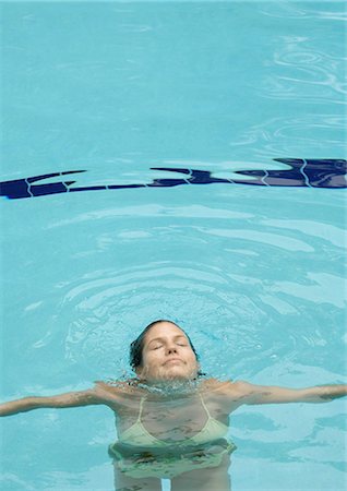 Woman emerging from water, in pool Stock Photo - Premium Royalty-Free, Code: 695-05763715