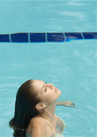 simsearch:632-07161660,k - Woman standing in pool, head back and eyes closed, side view Stock Photo - Premium Royalty-Free, Code: 695-05763713