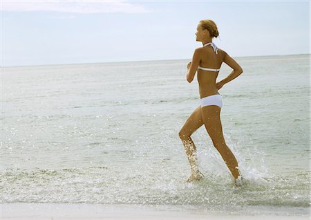 simsearch:632-02745223,k - Woman in bikini running in surf at beach Stock Photo - Premium Royalty-Free, Code: 695-05763733