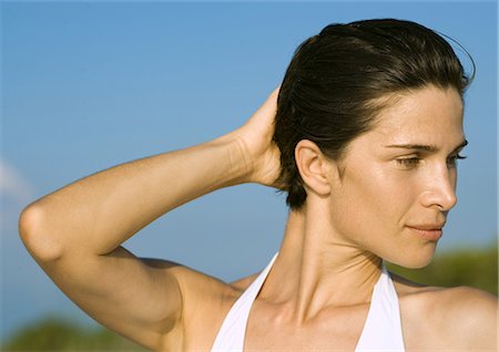 Woman with hand behind head, portrait Stock Photo - Premium Royalty-Free, Code: 695-05763740