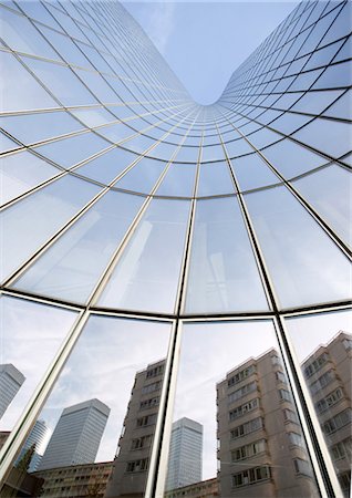 Skyscraper with reflection of buildings on facade, low angle, abstract view Stock Photo - Premium Royalty-Free, Code: 695-05763999