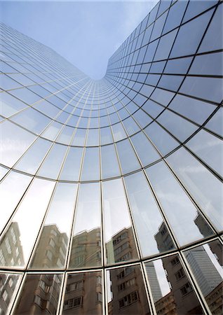 Skyscraper with reflection of buildings on facade, low angle, abstract view Stock Photo - Premium Royalty-Free, Code: 695-05763991
