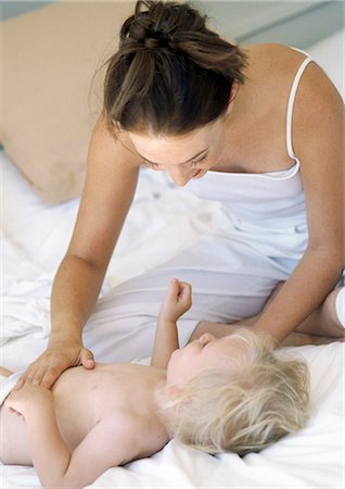 photo of boy sitting with his head down - Mother touching baby's stomach Stock Photo - Premium Royalty-Free, Code: 695-05774029