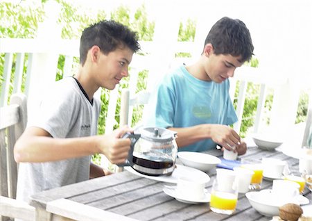 drinks on table coffee juice - Two teenage boys having breakfast outside Stock Photo - Premium Royalty-Free, Code: 695-05774184