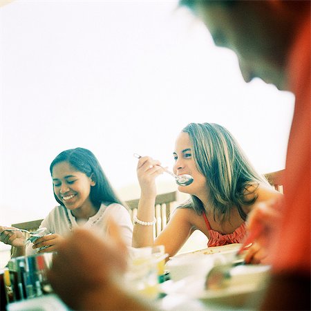 family teens terrace - Family sitting at table, smiling Stock Photo - Premium Royalty-Free, Code: 695-05774418