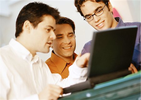 Three men looking at laptop computer Stock Photo - Premium Royalty-Free, Code: 695-05774456