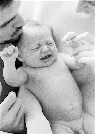 father and child cry - Mother and father with naked infant crying, b&w Stock Photo - Premium Royalty-Free, Code: 695-05774644