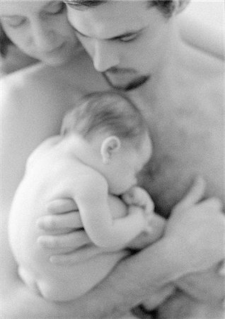 Mother and father with sleeping infant, b&w Stock Photo - Premium Royalty-Free, Code: 695-05774647