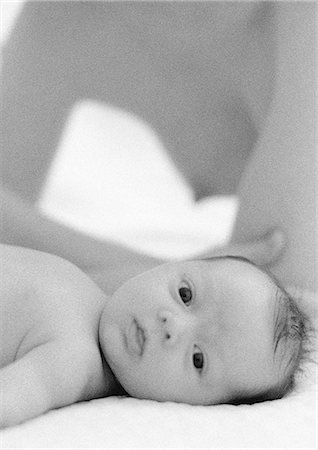 pregnant woman breast - Infant lying down looking at camera, nude mother in background, b&w Stock Photo - Premium Royalty-Free, Code: 695-05774642