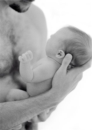 father holding a baby in his hands - Father holding infant in hands, b&w Stock Photo - Premium Royalty-Free, Code: 695-05774650