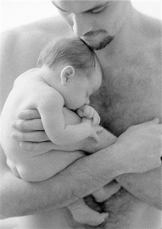 Father holding sleeping infant against bare chest, b&w Stock Photo - Premium Royalty-Free, Code: 695-05774652