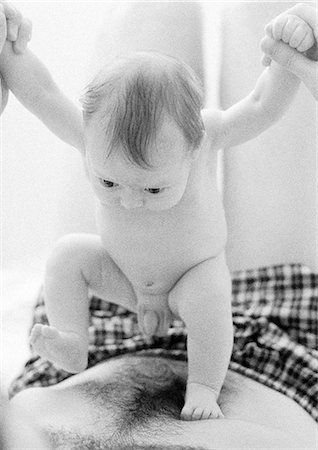 father holding a baby in his hands - Infant standing on father's bare chest, b&w Stock Photo - Premium Royalty-Free, Code: 695-05774653