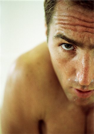 sweaty look of determination - Topless man looking at camera, partial view, close-up Stock Photo - Premium Royalty-Free, Code: 695-05774661