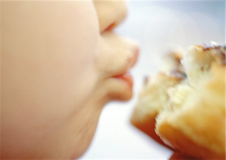 puckered lips profile - Young child eating sandwich, close-up. Stock Photo - Premium Royalty-Free, Code: 695-05774751