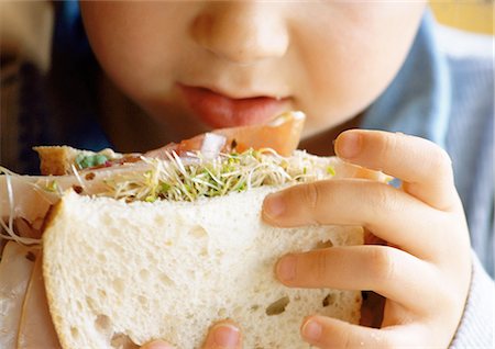 eat mouth closeup - Young child eating sandwich, close-up. Stock Photo - Premium Royalty-Free, Code: 695-05774752