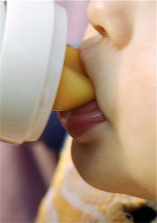 Baby drinking from bottle, close-up on mouth. Stock Photo - Premium Royalty-Free, Code: 695-05774768