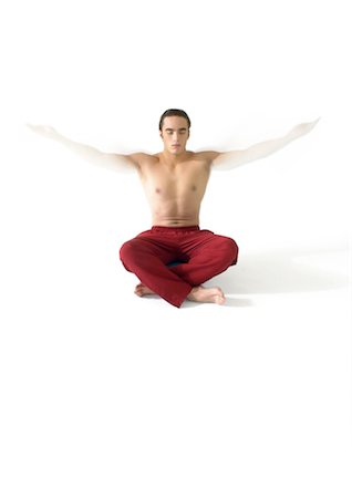 simsearch:695-03385803,k - Topless man sitting on floor indian style, meditating with arms out Stock Photo - Premium Royalty-Free, Code: 695-05774928