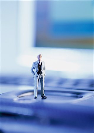 figures of computer networking - Small toy figure standing on computer keyboard, focus on figure Stock Photo - Premium Royalty-Free, Code: 695-05774950