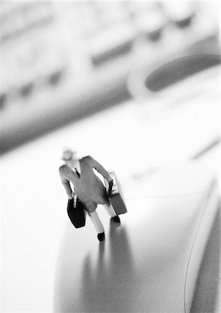 Small toy figure standing on computer mouse Stock Photo - Premium Royalty-Free, Code: 695-05774952
