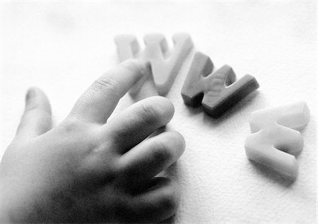 Child arranging letters spelling WWW Stock Photo - Premium Royalty-Free, Code: 695-05774986