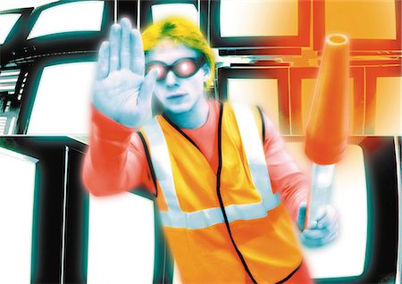 Young crossing guard standing in front of monitors, hand out toward camera, digital composite. Stock Photo - Premium Royalty-Free, Code: 695-05775022