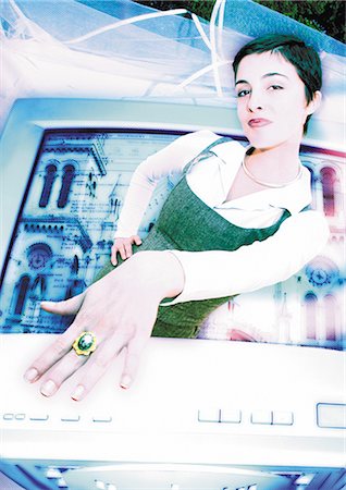 Young woman emerging from computer monitor, showing ring on finger, digital composite. Stock Photo - Premium Royalty-Free, Code: 695-05775034