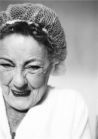 elderly face - Elderly woman wearing hair net, smiling, portrait, close-up, b&w Stock Photo - Premium Royalty-Free, Code: 695-05775090