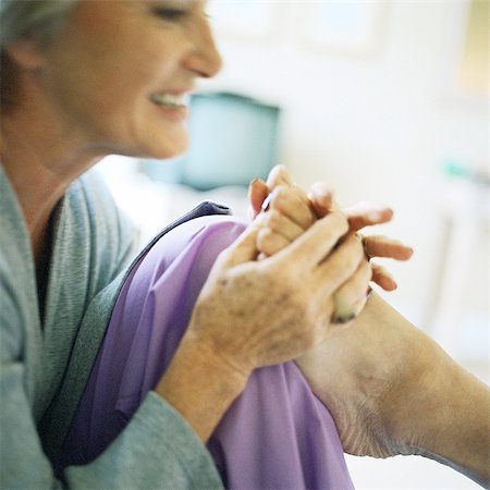 Woman massaging someone's foot, close-up Stock Photo - Premium Royalty-Free, Code: 695-05775113