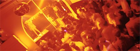 Crowd of people dancing at nightclub, blurred Stock Photo - Premium Royalty-Free, Code: 695-05775211