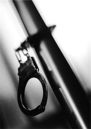 Handcuffs attached to pipe, b&w. Stock Photo - Premium Royalty-Free, Code: 695-05775525