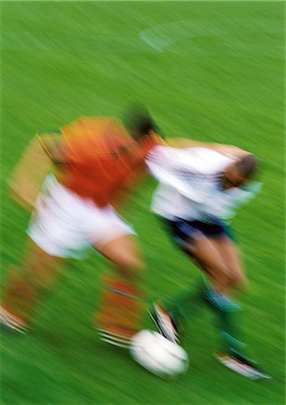 Two soccer players running with ball, blurred. Stock Photo - Premium Royalty-Free, Code: 695-05775826