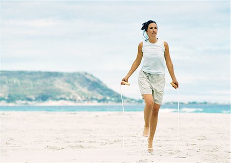 skipping ropes - Woman jumping rope on beach Stock Photo - Premium Royalty-Free, Code: 695-05775853
