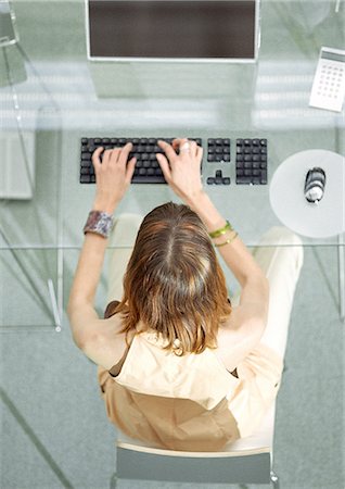 desk directly above - Woman at desk working on computer, elevated view Stock Photo - Premium Royalty-Free, Code: 695-05775943