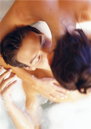 Woman bending over, kissing man in bath Stock Photo - Premium Royalty-Free, Code: 695-05775974