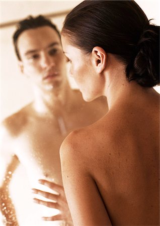 Nude couple facing each other through glass shower door, close-up Stock Photo - Premium Royalty-Free, Code: 695-05775976