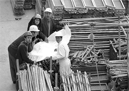 photo of civil engineering scaffolding - Five people examining blueprints in construction site, portrait, b&w Stock Photo - Premium Royalty-Free, Code: 695-05776080