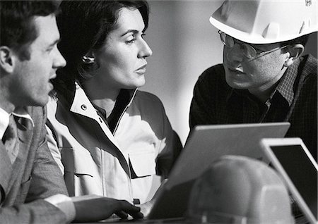 Trois personnes avec ordinateur portable, un casque protecteur, tête et épaules, b&w Photographie de stock - Premium Libres de Droits, Code: 695-05776099