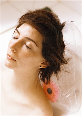 plastic bathtub - Woman taking bath, close-up of head resting on plastic pillow Stock Photo - Premium Royalty-Free, Code: 695-05776177