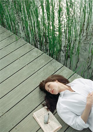 simsearch:695-05777385,k - Woman resting on wood bridge, head and shoulders, high angle view Stock Photo - Premium Royalty-Free, Code: 695-05776269
