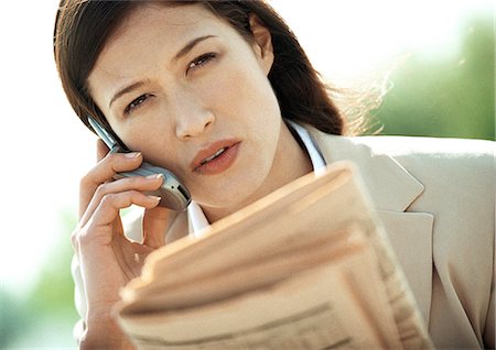 Businesswoman using cell phone, close-up, tilt Stock Photo - Premium Royalty-Free, Code: 695-05776287