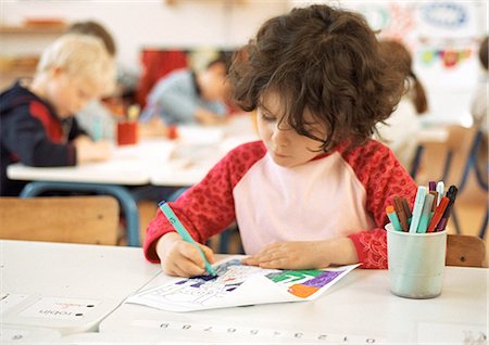simsearch:695-05776481,k - Child sitting at table, drawing, head and shoulders Stock Photo - Premium Royalty-Free, Code: 695-05776427